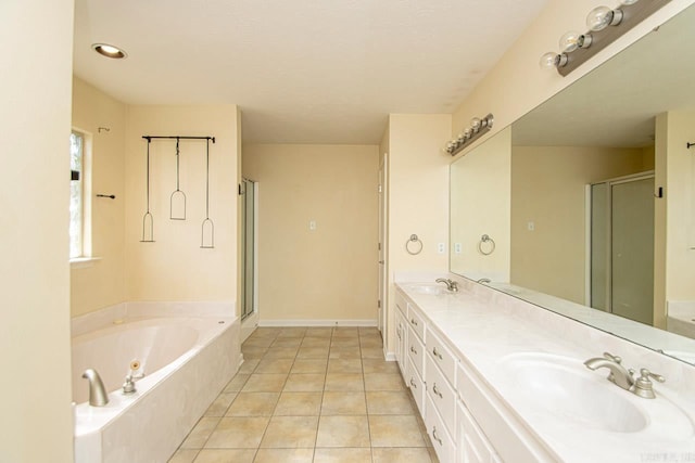 bathroom featuring vanity, tile patterned flooring, and separate shower and tub