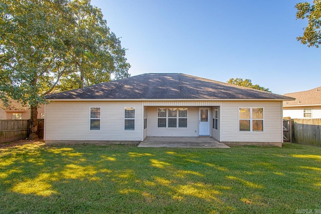 back of house with a patio and a yard