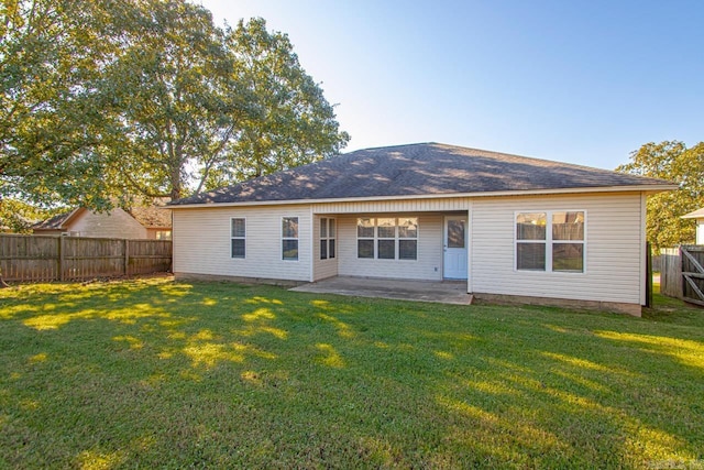 rear view of property with a lawn and a patio