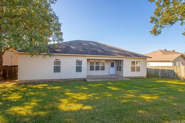 back of property featuring a patio and a yard