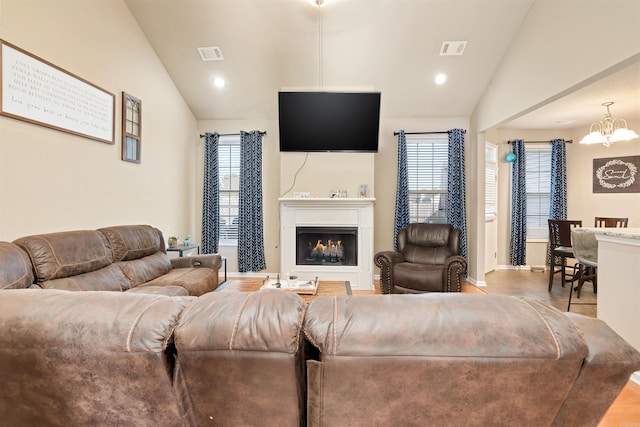 living room with vaulted ceiling and a chandelier