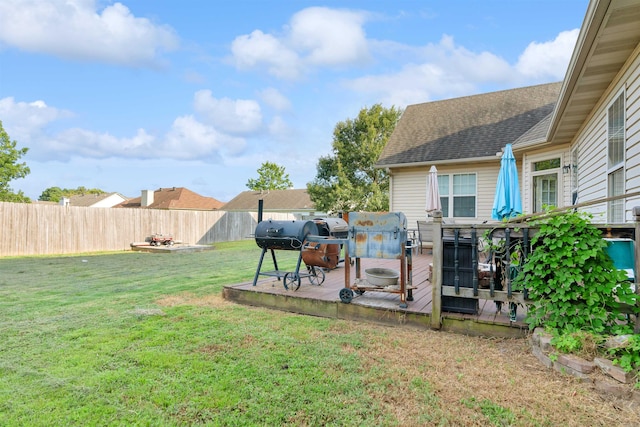 view of yard featuring an outdoor fire pit and a wooden deck