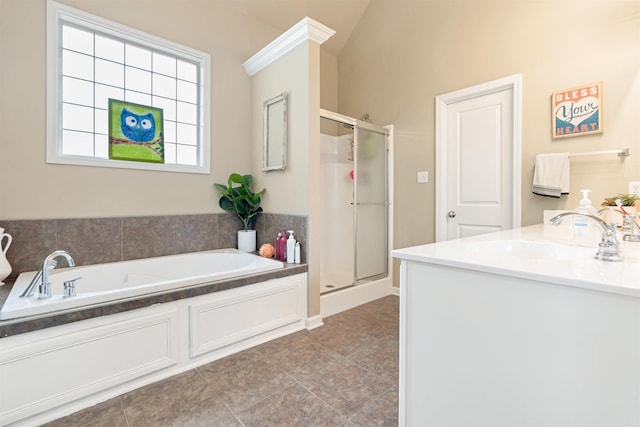 bathroom with shower with separate bathtub, vaulted ceiling, vanity, and tile patterned floors