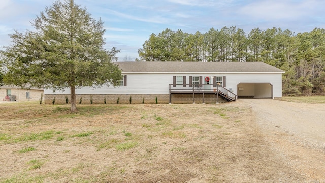 ranch-style home with a deck and a carport