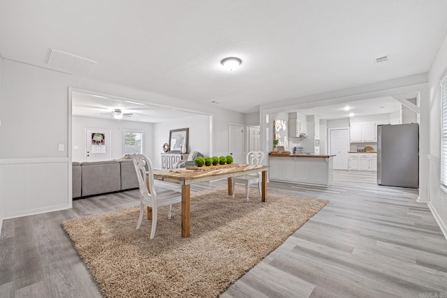 dining space featuring ceiling fan and light hardwood / wood-style flooring