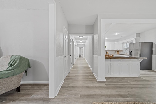 hall with light wood-type flooring