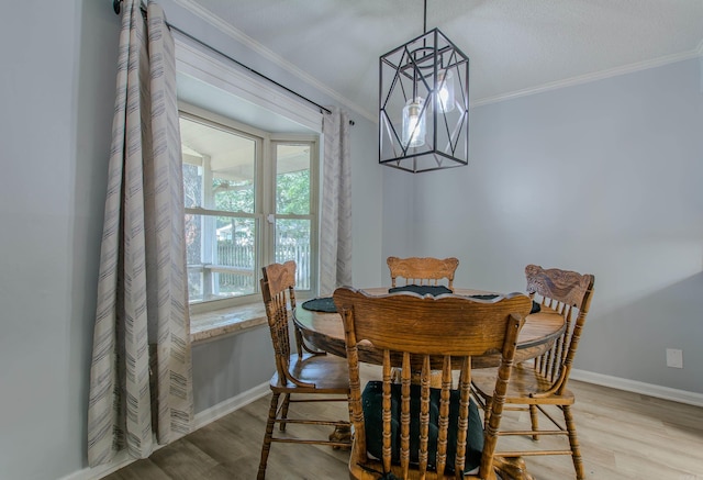 dining area featuring ornamental molding and light hardwood / wood-style floors