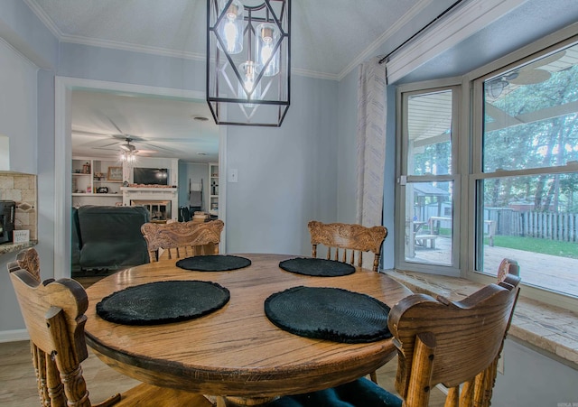 dining area with crown molding, ceiling fan, built in features, and hardwood / wood-style flooring