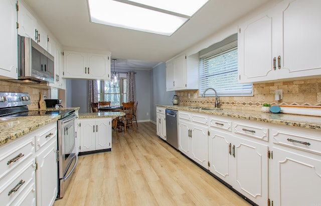 kitchen with appliances with stainless steel finishes and white cabinetry