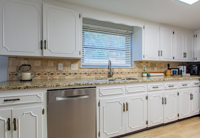 kitchen with white cabinetry, dishwasher, sink, and light stone counters