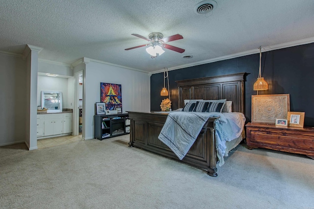 bedroom with a textured ceiling, ceiling fan, ornamental molding, ensuite bath, and light colored carpet