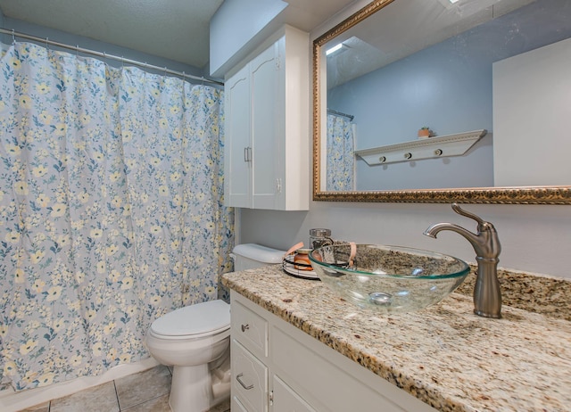 bathroom featuring curtained shower, vanity, toilet, and tile patterned floors