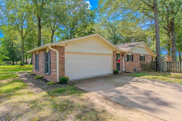 view of front of home with a front yard and a garage