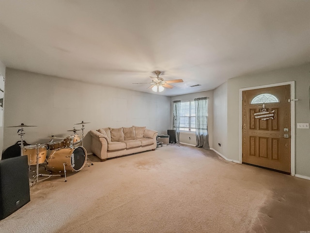 unfurnished living room with carpet and ceiling fan