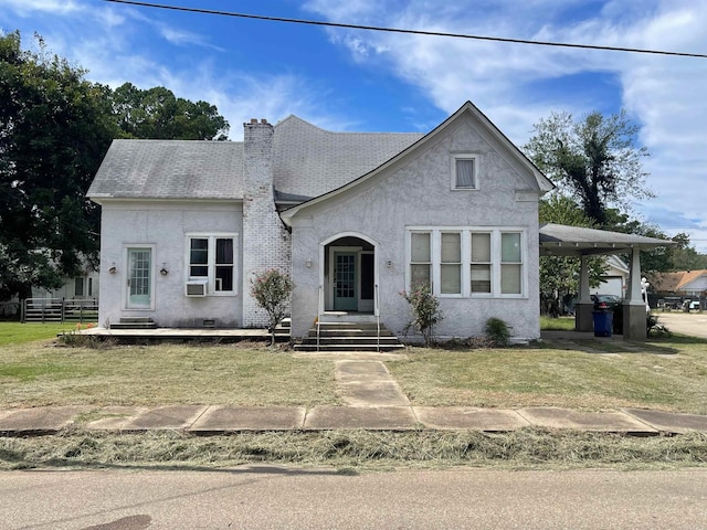 view of front of home with cooling unit, a carport, and a front lawn