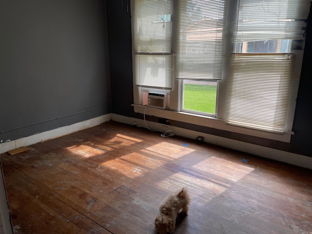 spare room featuring wood-type flooring and cooling unit