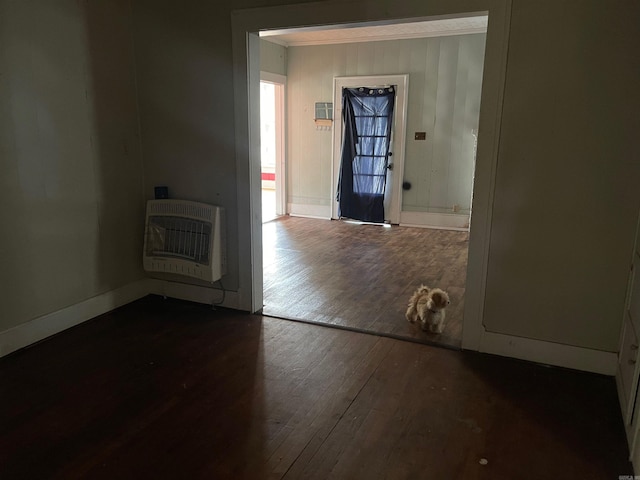 hallway featuring heating unit and dark hardwood / wood-style floors