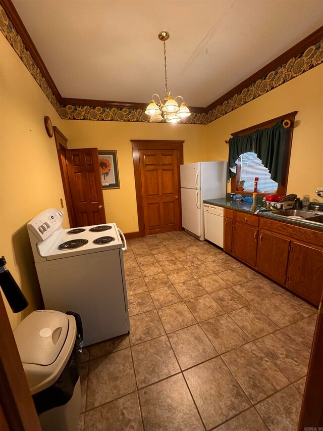 kitchen featuring a notable chandelier, white appliances, ornamental molding, and sink