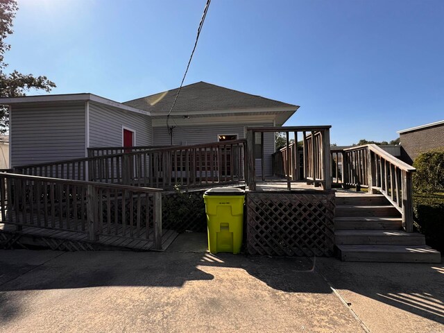 rear view of house featuring a deck