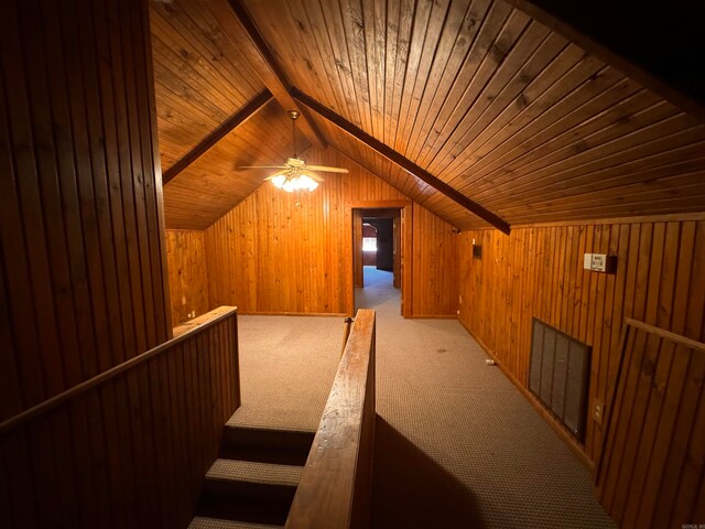 bonus room featuring vaulted ceiling with beams, light colored carpet, wood walls, and wooden ceiling