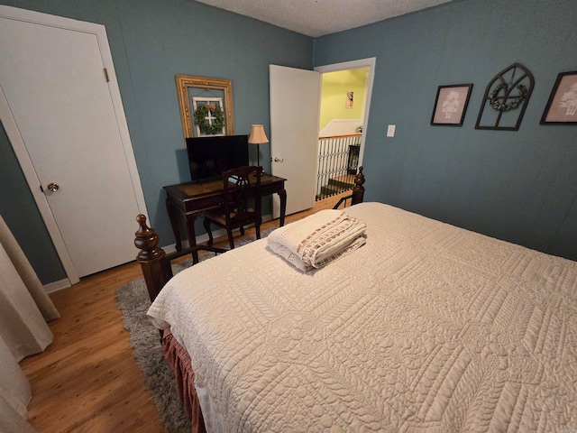 bedroom with wood-type flooring and a textured ceiling