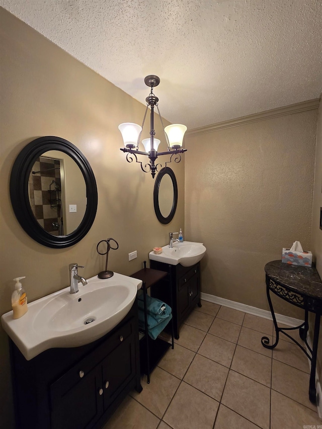 bathroom with tile patterned flooring, vanity, a textured ceiling, and a chandelier