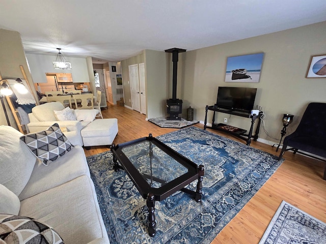 living room featuring a wood stove and wood-type flooring