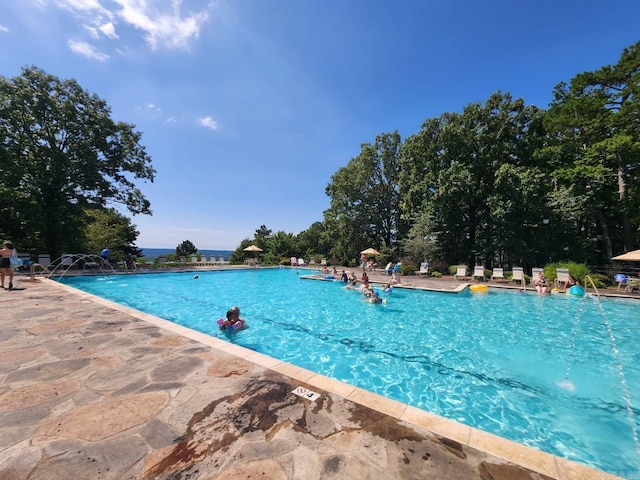 view of swimming pool with pool water feature