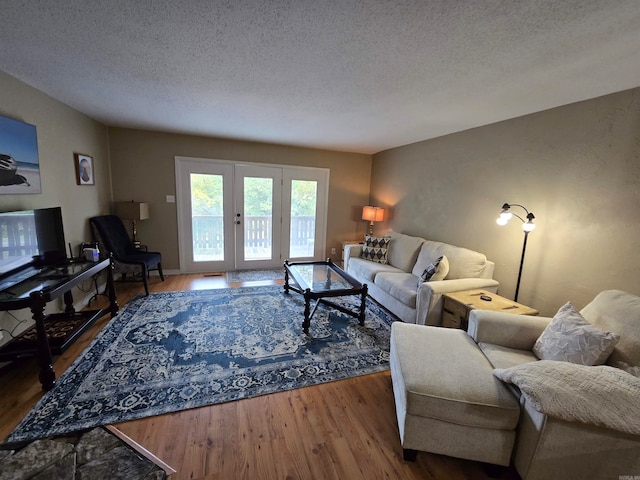 living room featuring a textured ceiling and hardwood / wood-style flooring