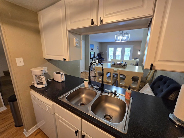 kitchen with french doors, wood-type flooring, dishwasher, sink, and white cabinetry