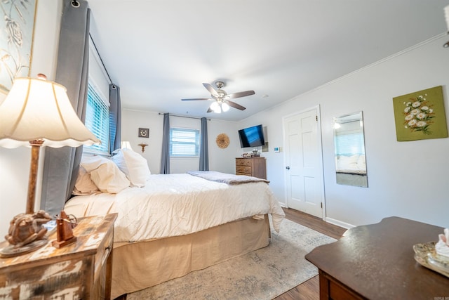 bedroom featuring ornamental molding, ceiling fan, and hardwood / wood-style flooring