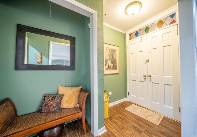 foyer entrance featuring hardwood / wood-style flooring and ornamental molding