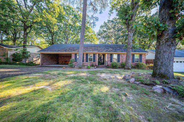 ranch-style home with a front yard and a garage