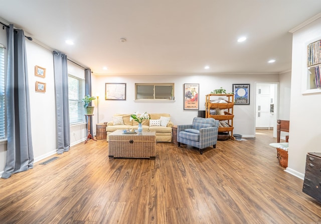 living room featuring crown molding and hardwood / wood-style floors