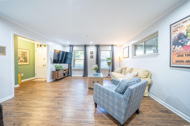 living room with crown molding and hardwood / wood-style flooring