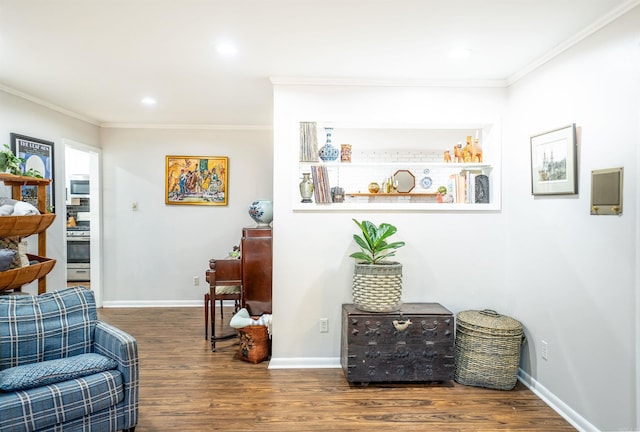 living area with ornamental molding and dark hardwood / wood-style flooring