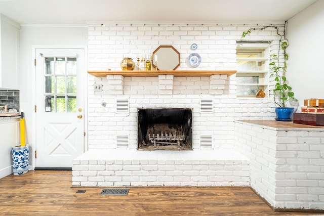 details with hardwood / wood-style floors and a fireplace