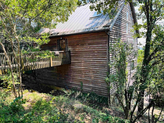 view of home's exterior with a wooden deck