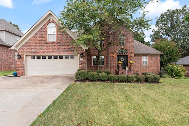 front facade featuring a garage and a front lawn