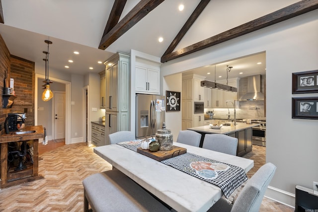 dining room featuring vaulted ceiling with beams and light parquet floors