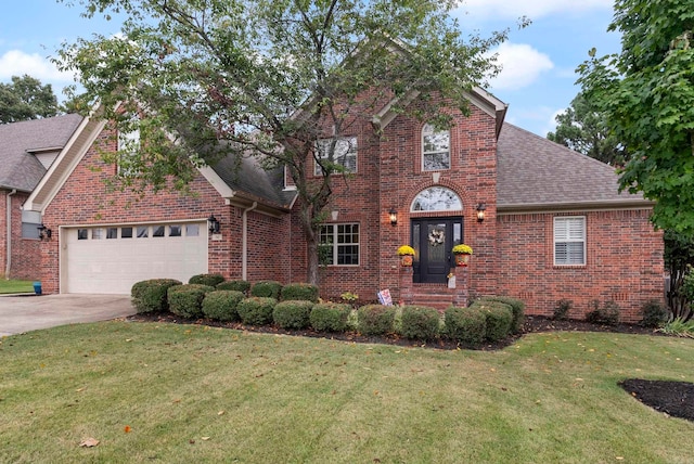 front of property with a garage and a front lawn