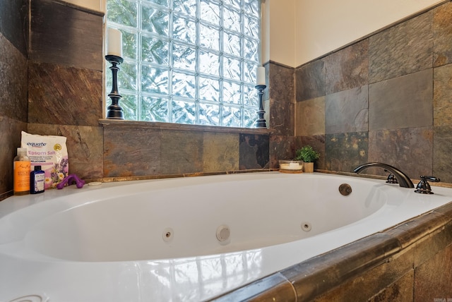 bathroom featuring tiled tub