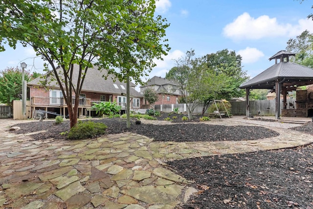 view of yard with a gazebo, a deck, and a patio area