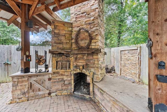 view of patio featuring an outdoor stone fireplace