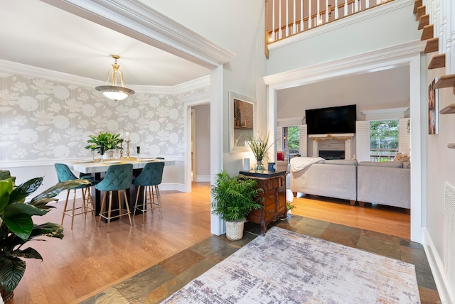 dining space featuring crown molding and dark hardwood / wood-style flooring