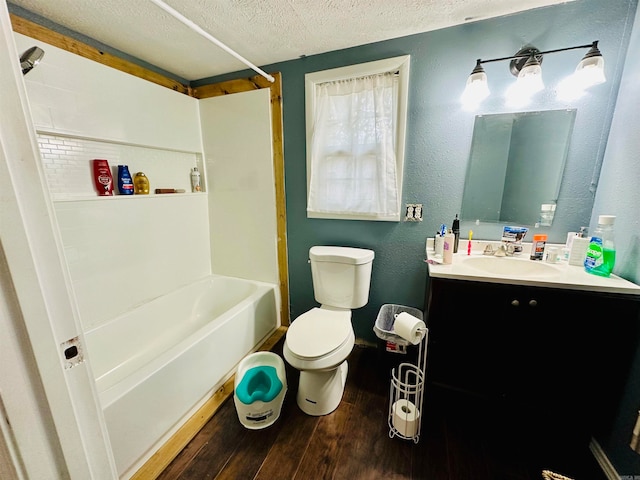 full bathroom with vanity, a textured ceiling, shower / bathtub combination, hardwood / wood-style floors, and toilet