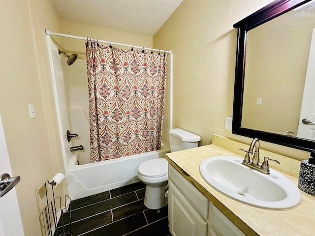 full bathroom with shower / bath combination with curtain, a textured ceiling, vanity, and toilet