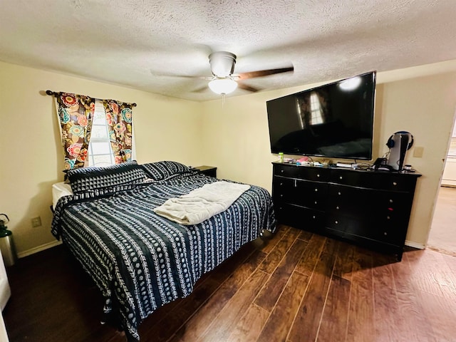 bedroom featuring a textured ceiling, dark hardwood / wood-style floors, and ceiling fan