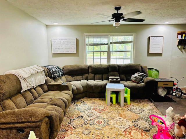 carpeted living room featuring a textured ceiling and ceiling fan