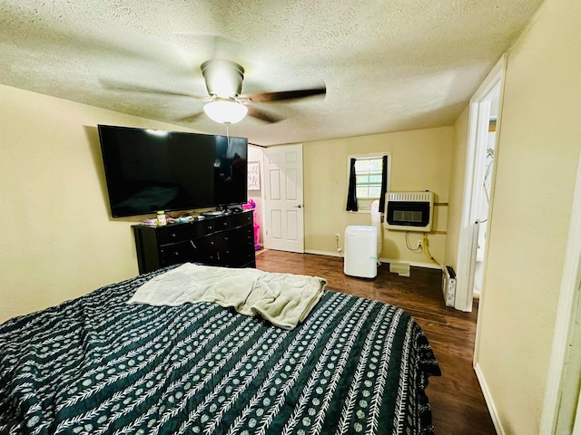 bedroom with heating unit, ceiling fan, dark hardwood / wood-style floors, and a textured ceiling